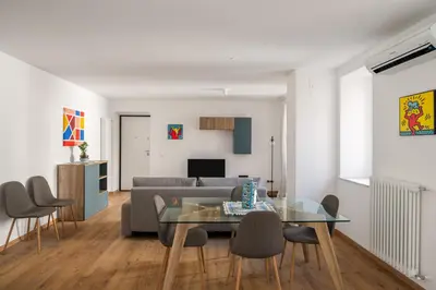a living room with a glass table and a couch at Little House Mavi by DomuSicily in Palermo