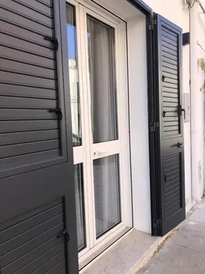 a pair of doors on the side of a house at Le Antiche Alcove in Terrasini
