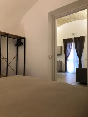 a bedroom with a bed and a large window at Le Antiche Alcove in Terrasini