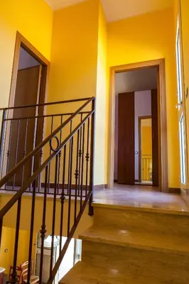 a staircase in a room with yellow walls at Case Vacanza Longo in Balestrate