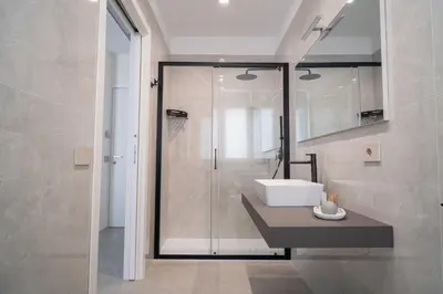 a bathroom with a sink and a shower at Acquamarina Rooms in Castellammare del Golfo
