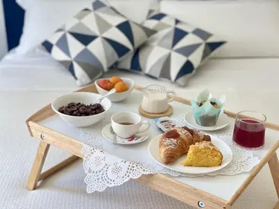 a tray of breakfast foods and coffee on a table at Acquamarina Rooms in Castellammare del Golfo