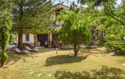 a house with trees in front of a yard at 3 Bedroom Lovely Home In Borgetto in Borgetto