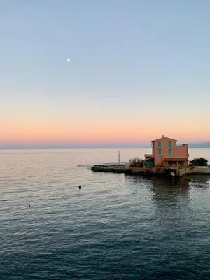 a house on a dock in the middle of the water at The White Lodge in Porticello