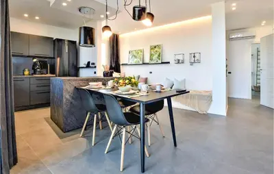 a kitchen and dining room with a table and chairs at Beautiful Apartment In Trappeto in Trappeto