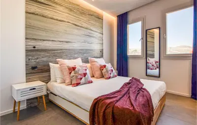 a bedroom with a bed with a painting on the wall at Beautiful Apartment In Trappeto in Trappeto