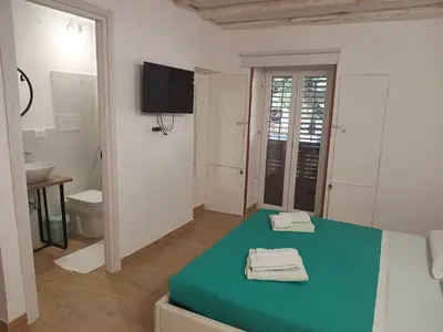 a room with a bed with towels on it at Talia Capo Massimo in Palermo