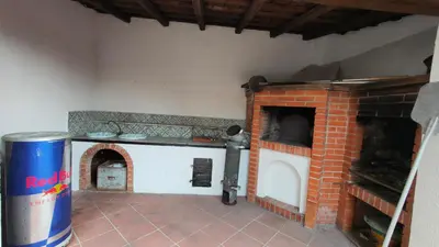 a kitchen with a brick oven in a room at Villa Calici in Pioppo