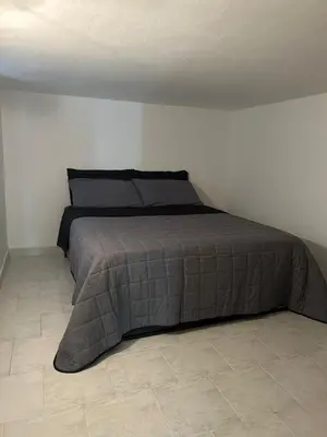 a bed in a bedroom with a tiled floor at margot palermo in Palermo