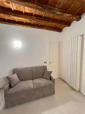 a living room with a couch in a white room at margot palermo in Palermo