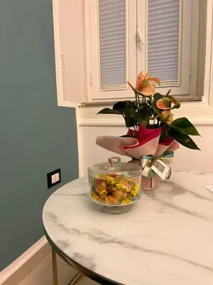 a table with a potted plant on top of it at margot palermo in Palermo