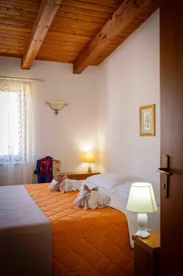 a bedroom with a bed with towels on it at Sunshine Apartments in Trappeto