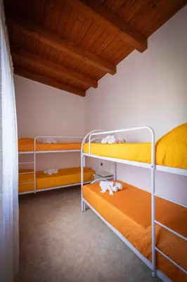 two bunk beds in a room with a wooden ceiling at Sunshine Apartments in Trappeto