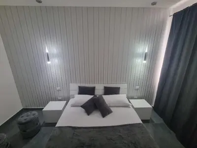 a bedroom with a large white bed with pillows at VILLA STELLA LUXURY IN SICILY with swimming pool for exclusive use in Balestrate