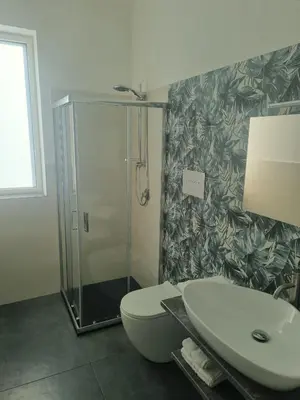 a bathroom with a shower and a toilet and a sink at VILLA STELLA LUXURY IN SICILY with swimming pool for exclusive use in Balestrate