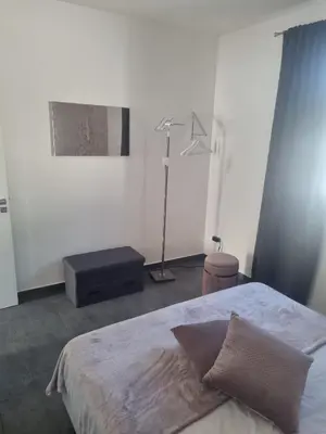 a white bedroom with a bed and a lamp at VILLA STELLA LUXURY IN SICILY with swimming pool for exclusive use in Balestrate
