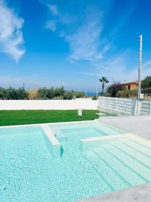 a swimming pool in the middle of a yard at VILLA STELLA LUXURY IN SICILY with swimming pool for exclusive use in Balestrate