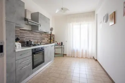 a kitchen with stainless steel appliances and a tile floor at CAMA Casa Vacanze - Qui vivi la vera storia normanna in Palermo
