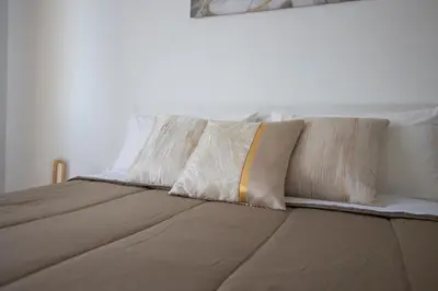 a bed with four pillows on top of it at CAMA Casa Vacanze - Qui vivi la vera storia normanna in Palermo