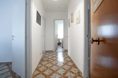 a hallway with a door and a tile floor at CAMA Casa Vacanze - Qui vivi la vera storia normanna in Palermo