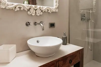 a white bathroom with a sink and a shower at Four Luxury Art in Palermo