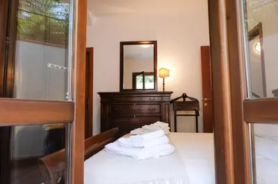 a room with a bed with a dresser and a mirror at Grande Villa con Giardino e BBQ vicino al Mare in Mondello