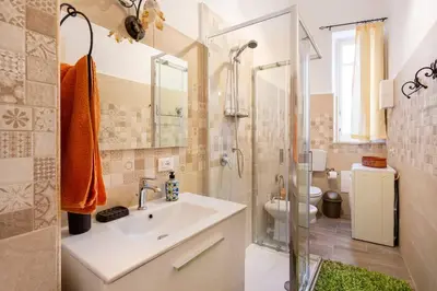 a bathroom with a sink and a shower and a toilet at Casa Lo Re in Bagheria