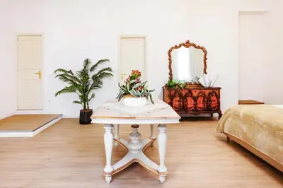 a room with a table and a bed and a mirror at Kepos Rooms and Suites in Palermo