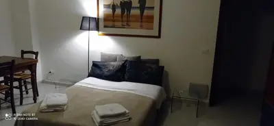 a bedroom with a bed with two towels on it at Mondello La Piazzetta Apartment in Palermo