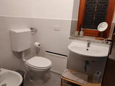 a small bathroom with a toilet and a sink at Mondello La Piazzetta Apartment in Palermo