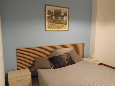 a bedroom with a bed and a picture on the wall at Mondello La Piazzetta Apartment in Palermo