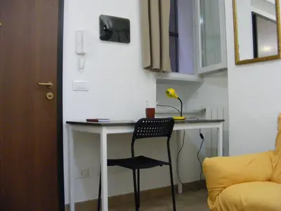 a desk with a chair in a small room at Makihome in Palermo