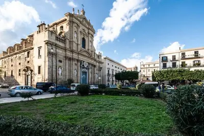 a large building with cars parked in front of it at At Kalsa Quiet Flowered Terrace! Free Parking! Ideal for remote working! in Palermo