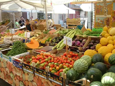 a market filled with lots of fruits and vegetables at At Kalsa Quiet Flowered Terrace! Free Parking! Ideal for remote working! in Palermo