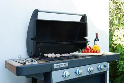 a barbecue grill with a plate of vegetables on it at Villa Charme in San Vito lo Capo