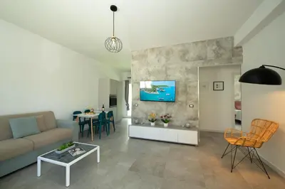 a living room with a couch and a table at Villa Charme in San Vito lo Capo