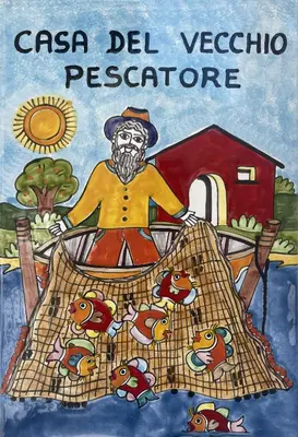 a book with a picture of a man with fish at Mondello - La casa del vecchio pescatore in Palermo