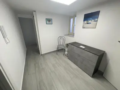a hallway with a dresser and a chair in a room at Mondello - La casa del vecchio pescatore in Palermo