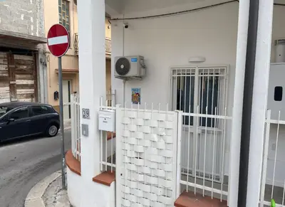 a building with a gate on the side of a street at Mondello - La casa del vecchio pescatore in Palermo