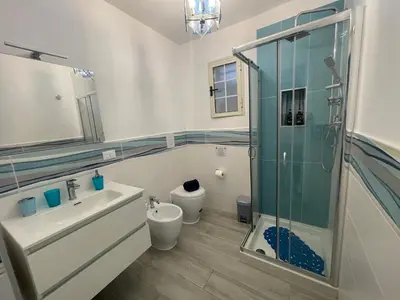 a bathroom with a shower and a sink and a toilet at Mondello - La casa del vecchio pescatore in Palermo