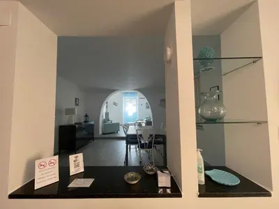 a view of a living room with a table with vases at Mondello - La casa del vecchio pescatore in Palermo