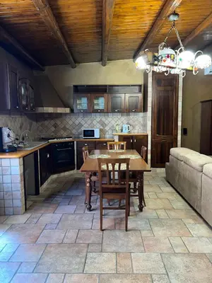 a kitchen with a table and chairs and a couch at Bacio del sole Apartment in Palermo