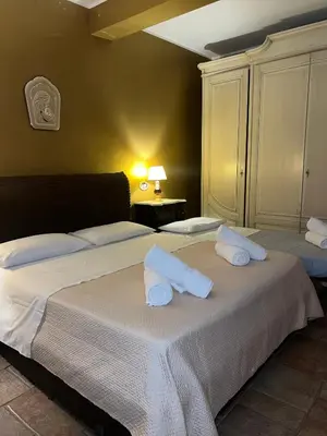 a bedroom with two beds with towels on them at Bacio del sole Apartment in Palermo