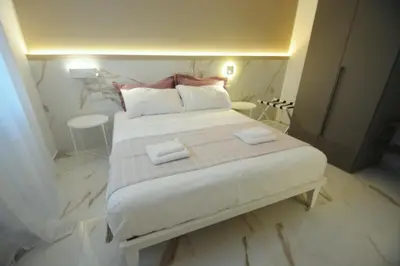 a bedroom with a large bed with two towels on it at ARIOSTO HOME in Palermo
