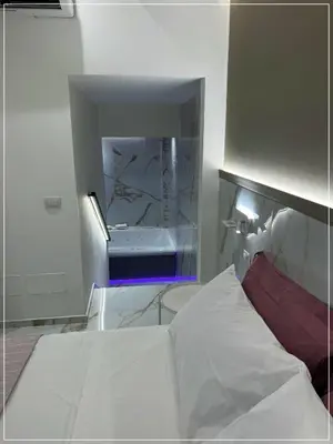 a bedroom with a white bed and a sink at ARIOSTO HOME in Palermo