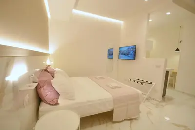 a white bedroom with a bed and a toilet at ARIOSTO HOME in Palermo