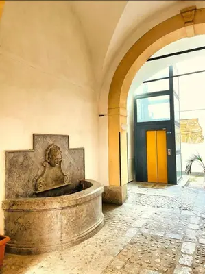a building with a fountain in the middle of a room at I Carrettieri - a few steps from the Cathedral in Palermo