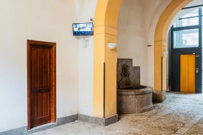 a building with a statue next to a door at I Carrettieri - a few steps from the Cathedral in Palermo