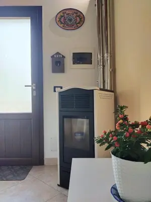 a fireplace in a living room next to a door at Casetta Matotta, casa vacanze a Mondello - Palermo in Mondello