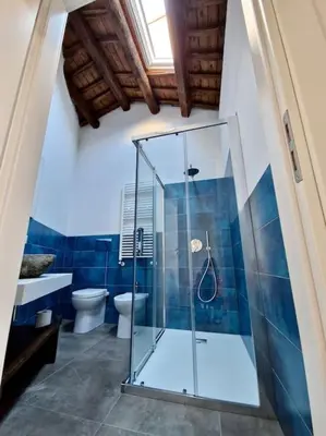 a bathroom with a glass shower and a toilet at Tuttoporto-Apartments LEVANTE in Palermo